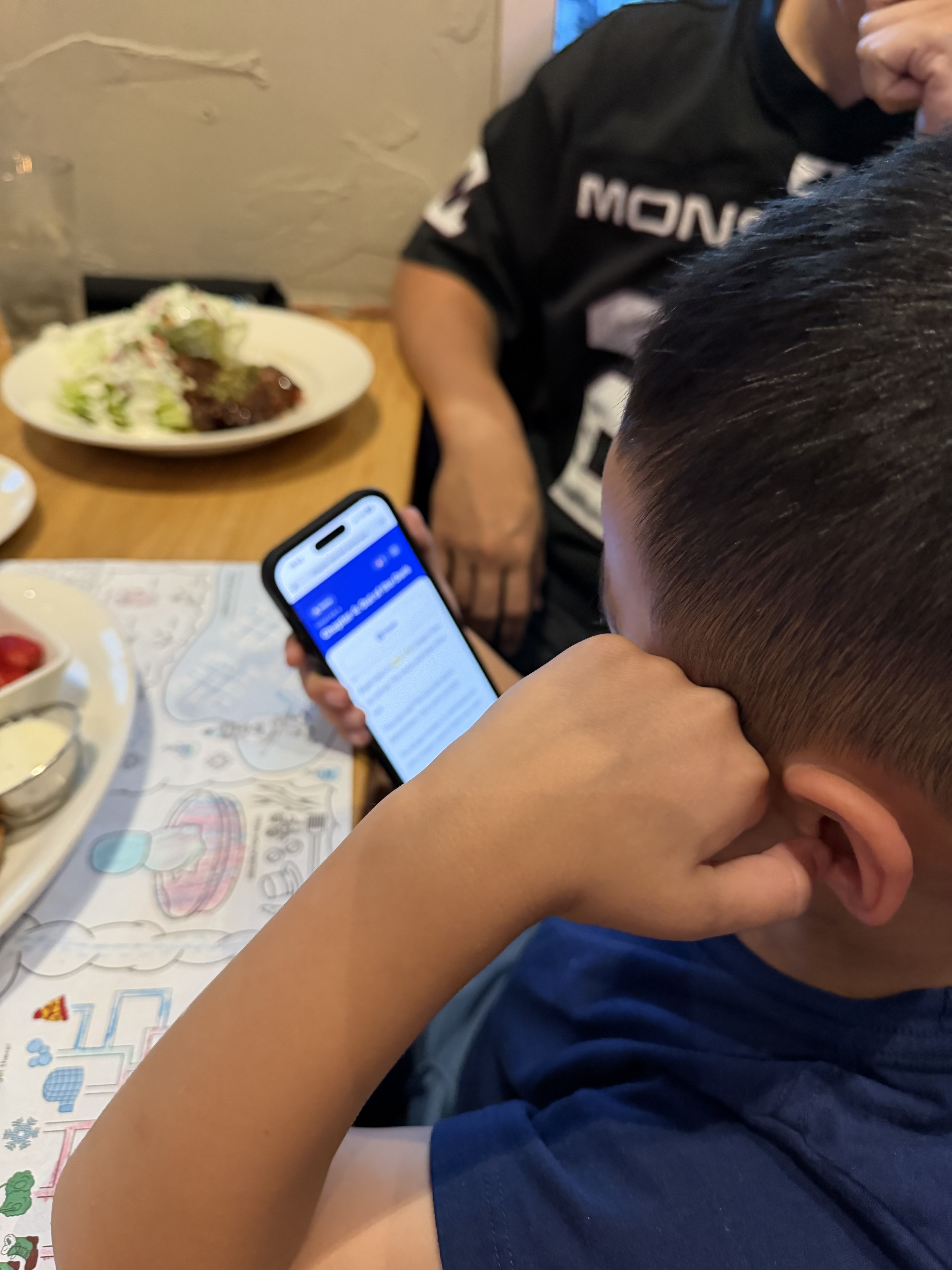 A kid reading Page One at the dinner table